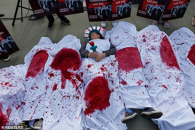 Abortion rights advocates participate in a 'die-in' outside the Supreme Court