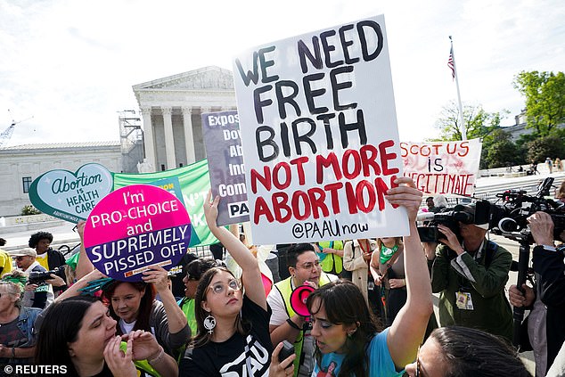 Pro- and anti-abortion rights protesters face arguments in front of the Supreme Court on Wednesday