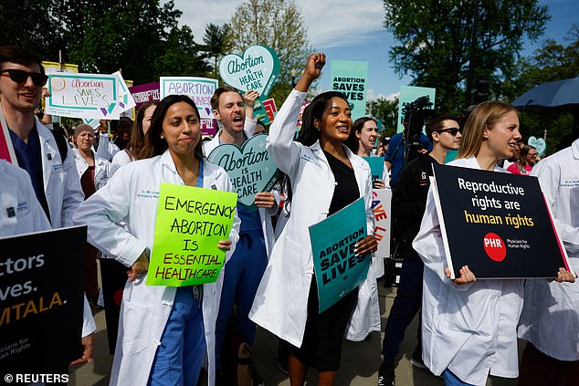 A group of doctors join pro-abortion rights activists who took part in a 'die-in' outside the Supreme Court as it heard arguments in the case of Idaho v. United States