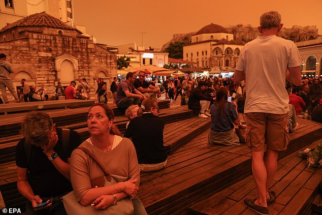 The sudden change in weather also caused temperatures to soar, with the mercury on the southern island of Crete reaching 30°C (86F) – more than 20°C (68F) higher than most of northern Greece (photo : people look at the orange sky in Athens yesterday)