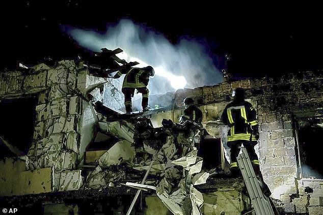 In this photo provided by Mayor of Odesa Hennadii Trukhanov in Telegram, firefighters work at the scene of a burning building after a Russian drone attack in Odesa, Ukraine, Tuesday, April 23