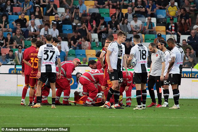 Players from both sides gather around Ndicka to express their concerns during the match