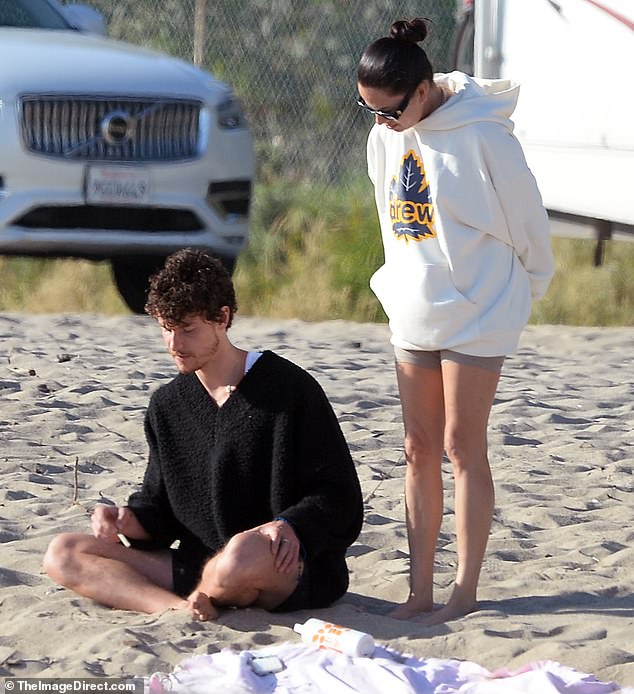 He wore black shorts and brown suede clogs, which he took off to the beach for his comfortable, casual beach look.  This comes a day after reuniting with his boyfriend - who wore a white hoodie with taupe biker shorts - for their first public hangout in four months