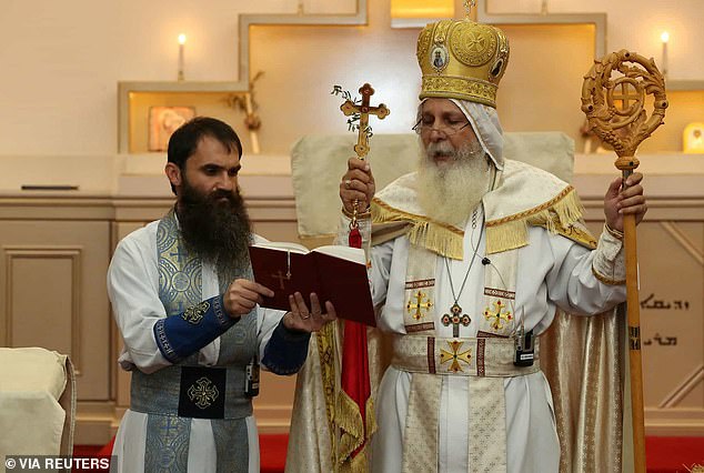 The photo shows parish priest Father Isaac Royel (left) and Bishop Mar Mari Emmanuel (right), both of whom suffered stab wounds