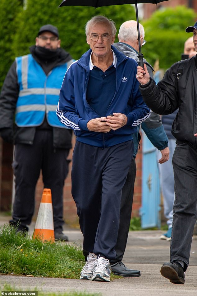 A crew member held up an umbrella before filming began