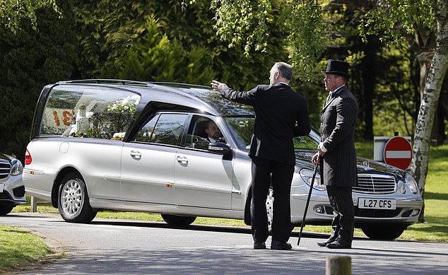 A hearse is driven for George's service which took place earlier today