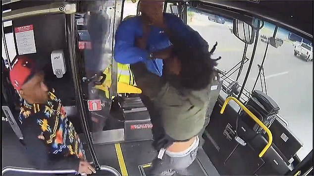 Another passenger comes to the front of the bus and tries to break up the fight