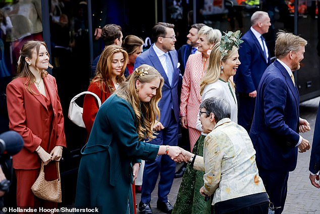 The family walked a route through the city, collected floral gifts and greeted onlookers who had gathered to wish the royal family well on King's Day