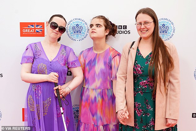 Pictured: the blind musician (center) at the coronation concert with mother Candice, left, and her teaching assistant Lisa, right