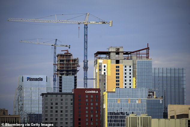 Construction cranes above tall condominium buildings in downtown Nashville