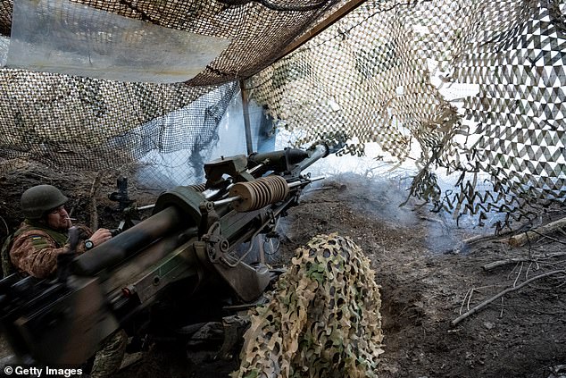 Ukrainian gunman Vasyl Zozulia fires the cannon as soldiers of the 95th Brigade of the Ukrainian Army fire 105mm artillery shells from a British-made L119 howitzer at Russian positions