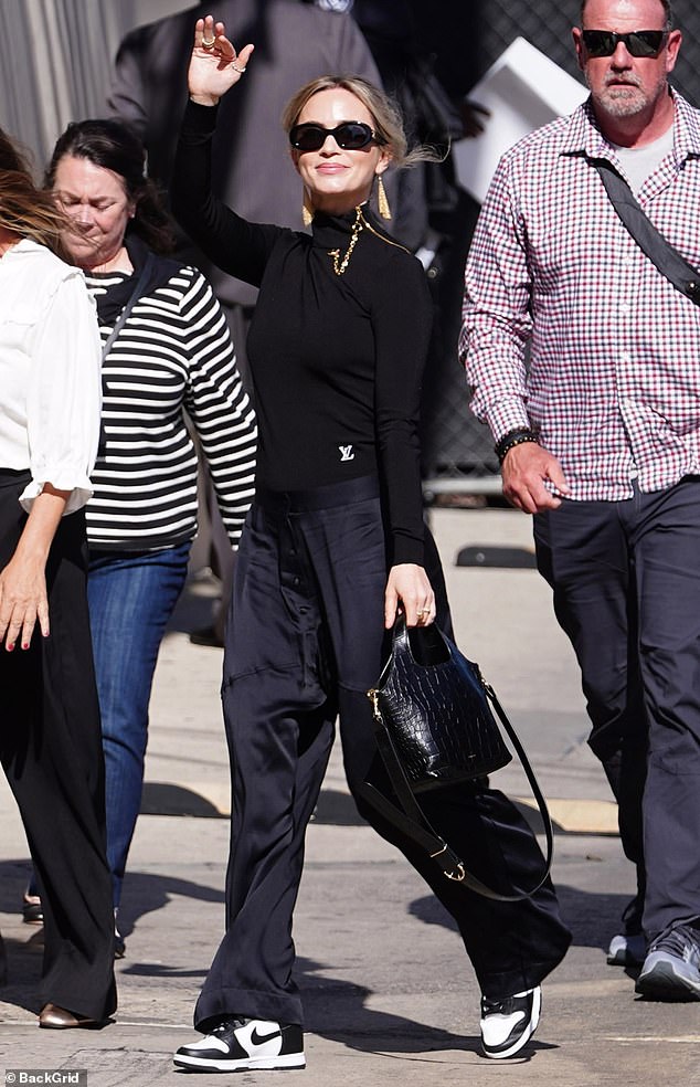 She complemented the look with a black alligator handbag