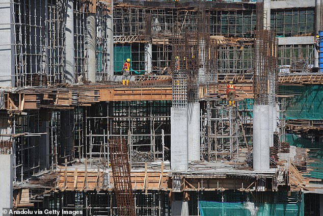 Workers complete construction of a multi-storey building in Nusantara