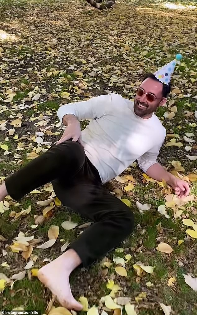 In the footage, Jock tried to launch a cork from a bottle of champagne for his friend Andy to catch, but instead fell to the ground (pictured) when the cork hit him in the face.