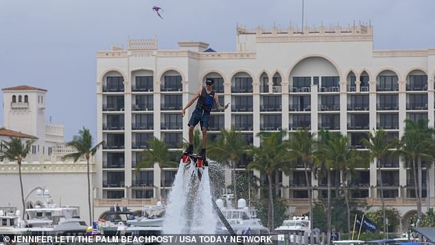 A man was also seen floating in the air attached to a water jet pack with a phone in hand