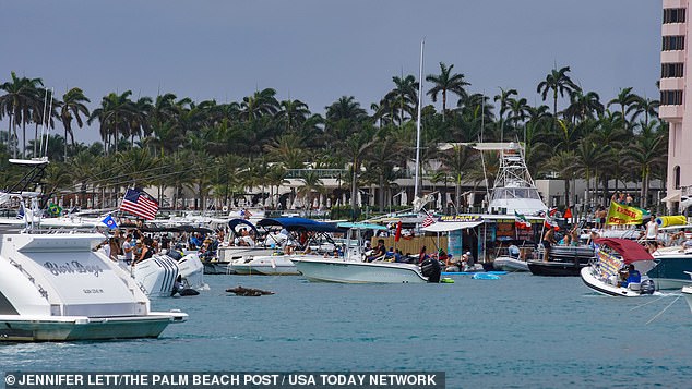 Partygoers are seen in the lake as they started the summer party