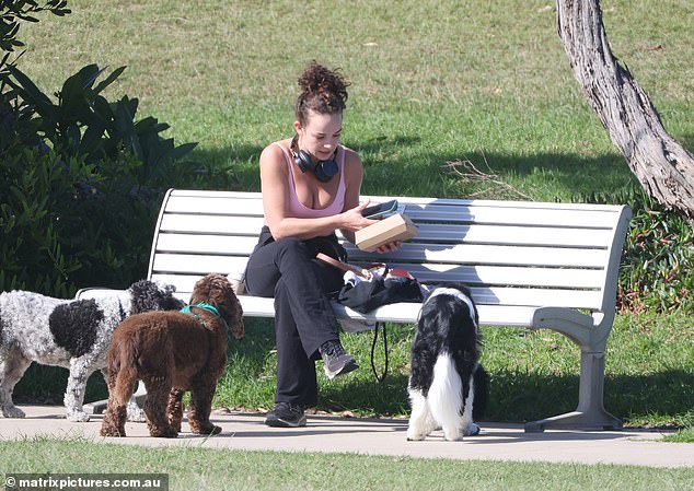 Makeup-free, Abbie tied her curly locks back and completed her look with a pair of black sneakers and headphones