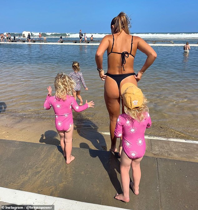 She also posted a photo showing off her athletic figure in a G-string bikini while having fun with Nelson and her daughters on the beach.