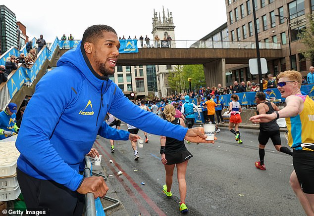 Anthony Joshua was spotted handing out Lucozade and cheering on the London marathon runners on Sunday