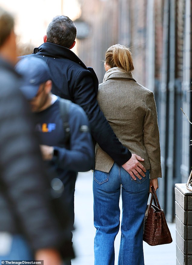 The handsome star playfully patted his beautiful wife's perky derriere as they entered the famous Italian restaurant