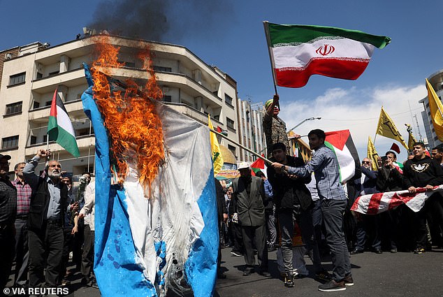 Iranians burn an Israeli flag during a gathering to mark Quds Day and the funeral of Islamic Revolutionary Guard Corps members killed last week in a suspected Israeli airstrike on the Iranian embassy complex in Damascus, Syria