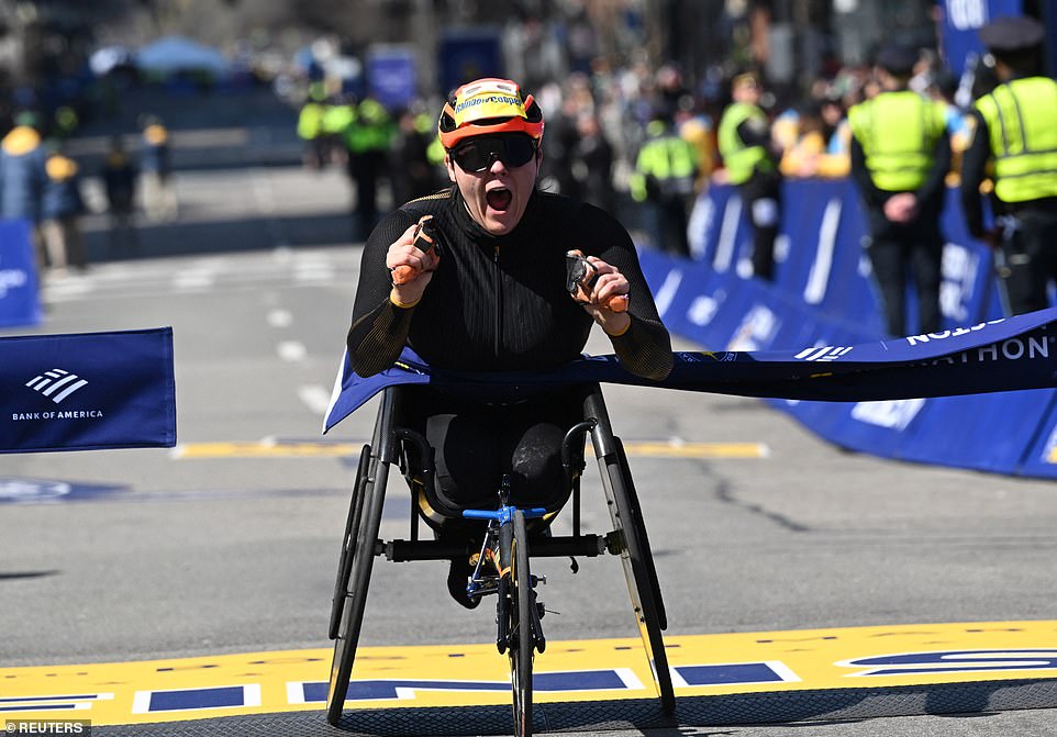 The British Eden Rainbow-Cooper crosses the finish line and wins the women's wheelchair race