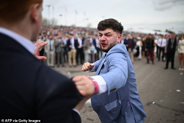 Shocking photos show a man in a gray suit with blood around his mouth apparently preparing to punch another racegoer, holding one hand up in an apparent attempt to stop him