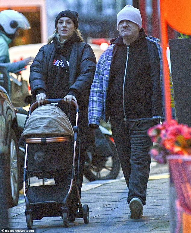 Damien Hirst and his pregnant partner Sophie Cannell pushed their pooch in a dog stroller as they stepped out ahead of the arrival of their first child on Wednesday