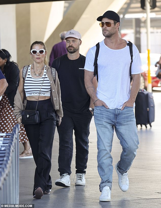 Elsa Pataky, 47, (left) showed off her fit physique as she arrived at Sydney Airport with husband Chris Hemsworth, 40, on Saturday