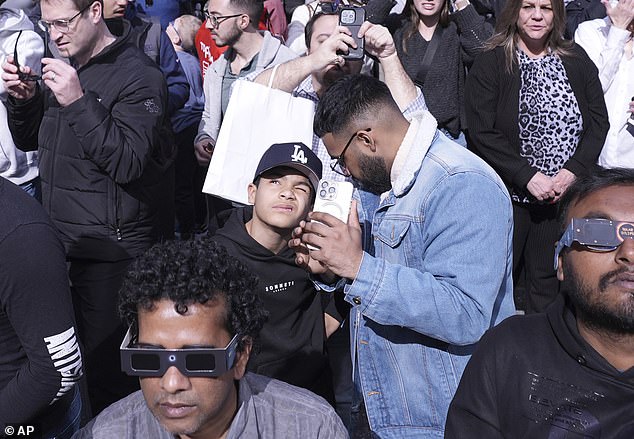 An estimated 32 million people enjoyed one of the most spectacular sights visible from Earth as a solar eclipse swept across North America on Monday.  Above, people view Monday's solar eclipse from New York's Times Square on April 8, 2024