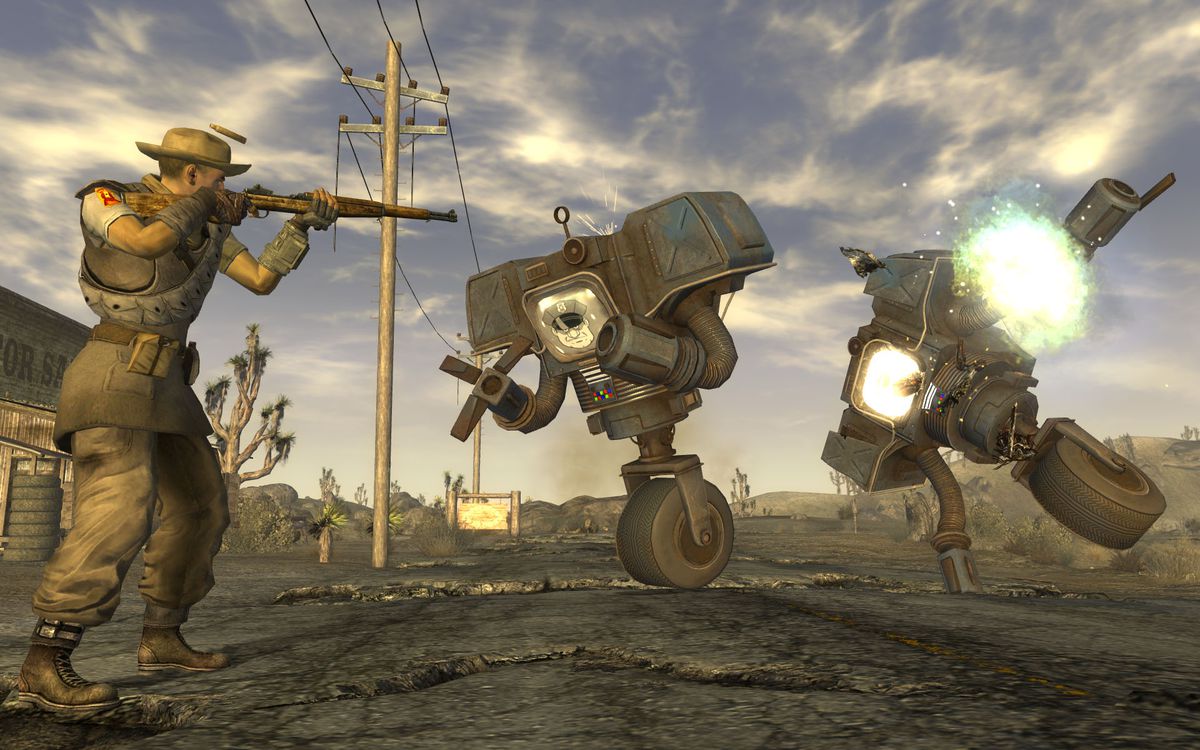 A player in Fallout: New Vegas is confronted by two security machines, large robots with grasping hands that balance on one wheel, carrying a gun.