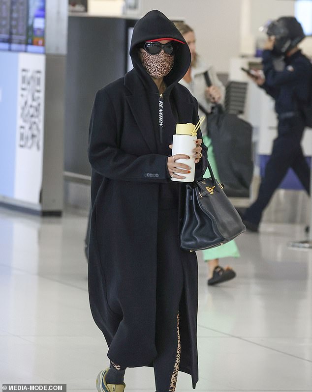 Rita Ora made sure no one would see her as she left Sydney airport on Sunday.  Pictured