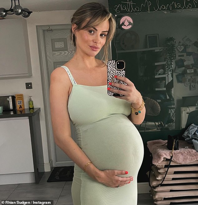 Heavily pregnant Rhian Sugden displays her baby bump in a