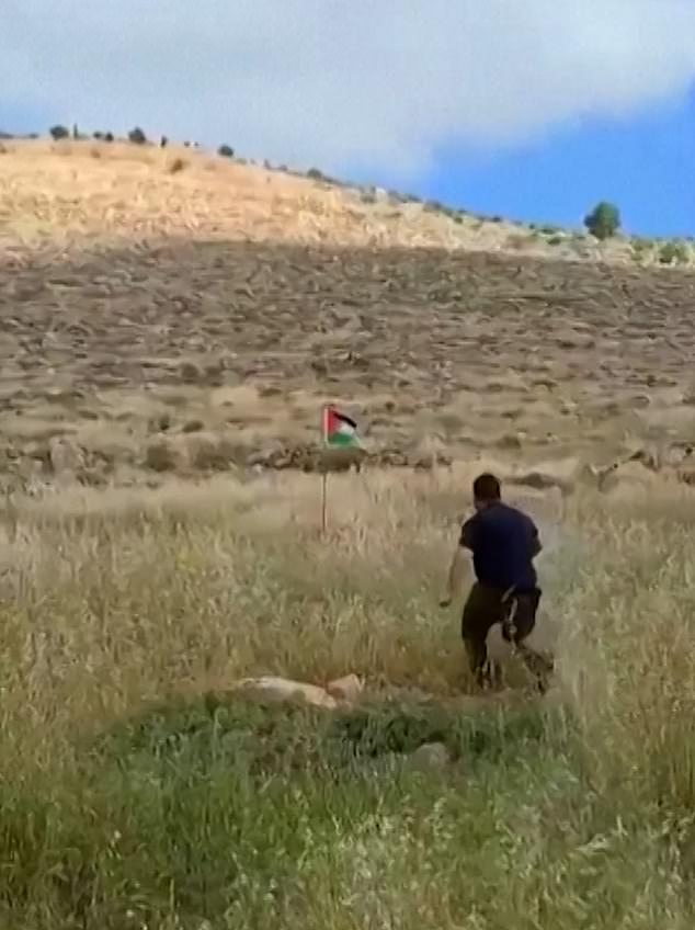 An IDF reservist is seen in footage charging at a Palestinian flag erected near the West Bank settlement of Kochav Hashahar.