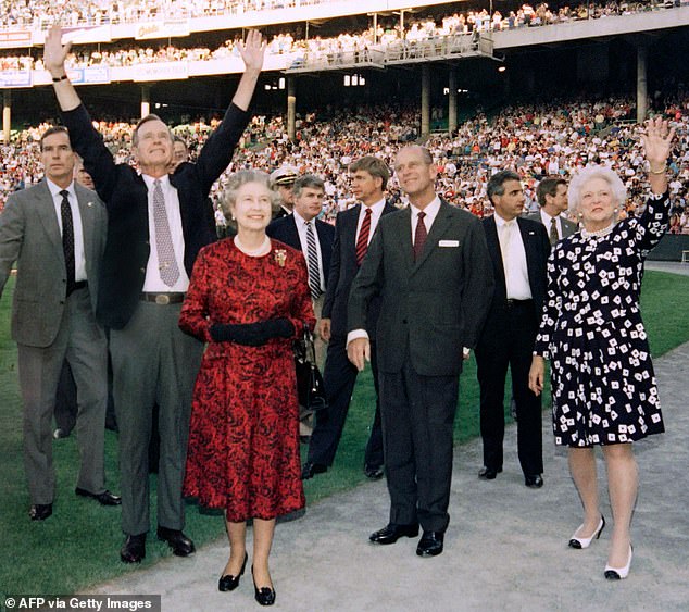 President George HW Bush (second from right) extends his arms to the crowd during a Baltimore Orioles game where he brought Queen Elizabeth (center right) and Prince Philip (center left) during a state visit with First Lady Barbara Bush (right ) on May 15, 1991