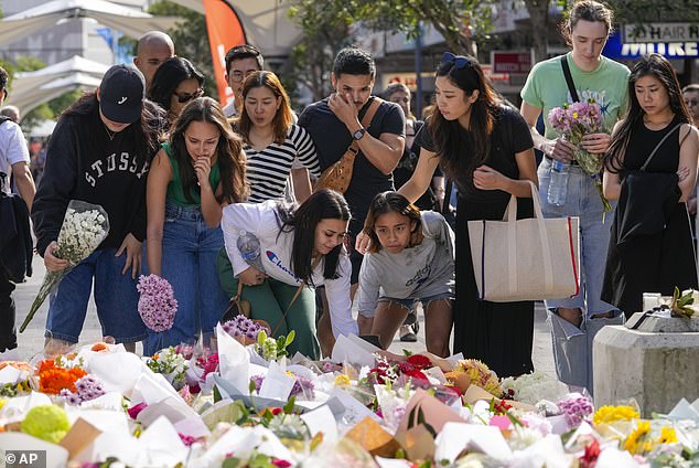 Store employees from Calvin Klein and Tommy Hilfiger lay flowers at the Bondi Junction memorial on Monday