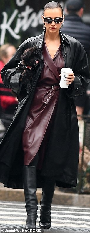 The 38-year-old Russian fashionista wore a daring triple leather ensemble, including a flowing black coat that fluttered in the wind