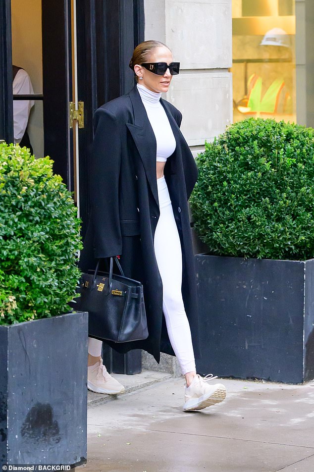 Jennifer Lopez showed off a hint of her toned stomach as she emerged from her Manhattan hotel on Thursday