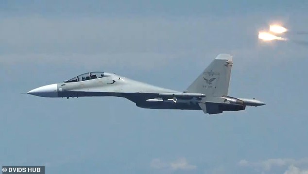 Last month, 32 Chinese warplanes were detected over Taiwan in just 24 hours, the country's Defense Ministry said.  Pictured: File photo of a Chinese jet near an American fighter plane