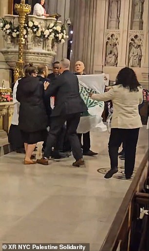 During the traditional Easter vigil, demonstrators unfurled a flag in front of the crowd with the text 'SILENCE = DEATH'