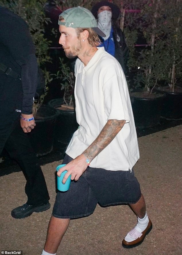 The hitmaker - who celebrated his 30th birthday last month - wore an oversized white polo shirt with contrasting wide dark blue denim shorts