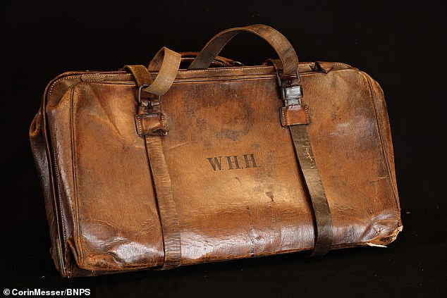 A leather bag that protected the violin the bandmaster was playing on the Titanic when the ship sank sells at auction for £120,000