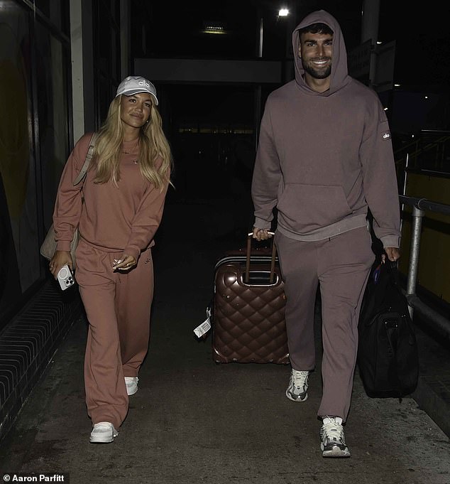 Love Island's Molly Smith and Tom Clare appeared in good spirits as they arrived back in Manchester after their lavish Dubai getaway