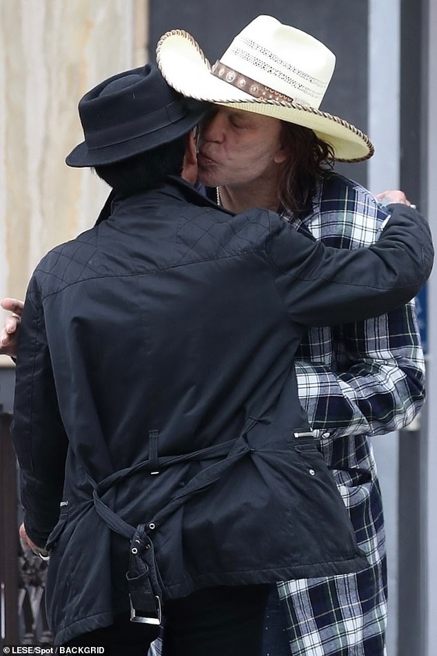 The 71-year-old artist plants a kiss on his acquaintance's cheek after leaving an Italian cafe together