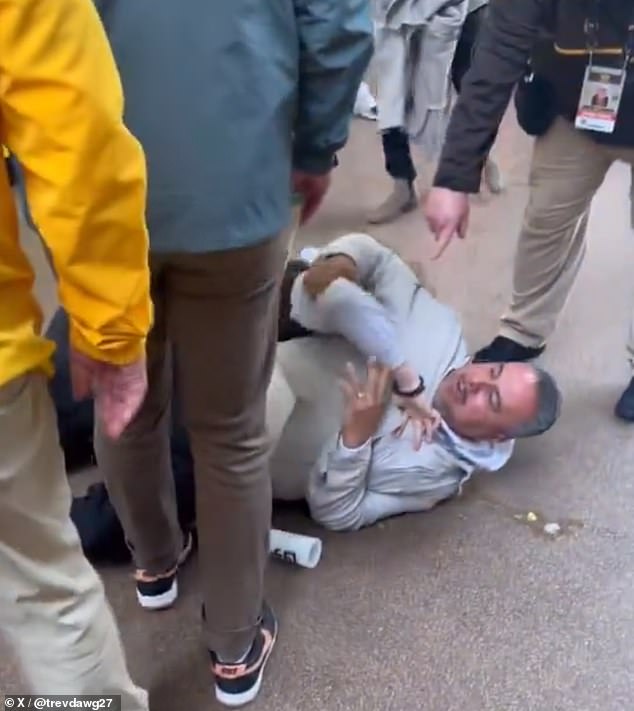 A fan in a gray sweatshirt tried to strangle a man in brown shit at Petco Park on Saturday.