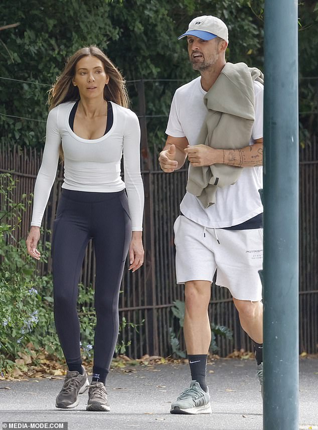 Nadia Bartel, 38, (left) enjoyed a romantic stroll with boyfriend Peter Dugmore (right) on Saturday as the pair walked laps around the Botanic Gardens in Melbourne