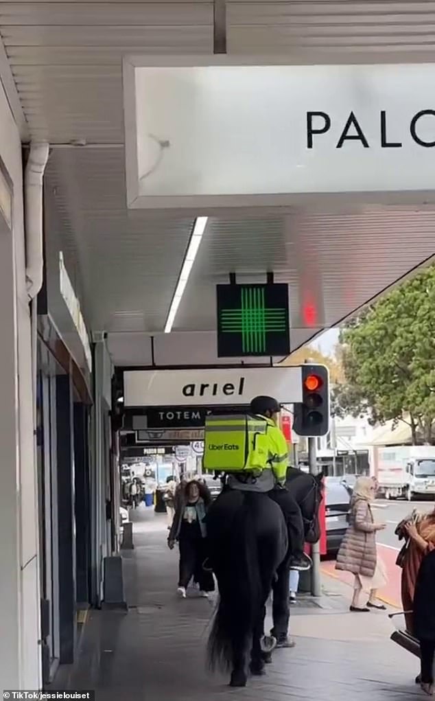 An UberEats delivery driver has been filmed using a bizarre mode of transport to deliver customers' meals to their doorsteps