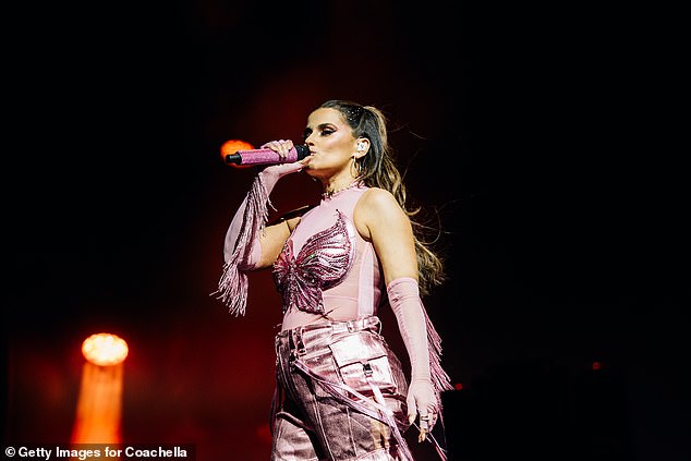 Looking incredible in a pink ensemble, she was seen belting out the lyrics 'Move your body like a nympho' from her 2006 hit Maneater before suffering an epic spill, but still quickly regained her composure and continued her show.