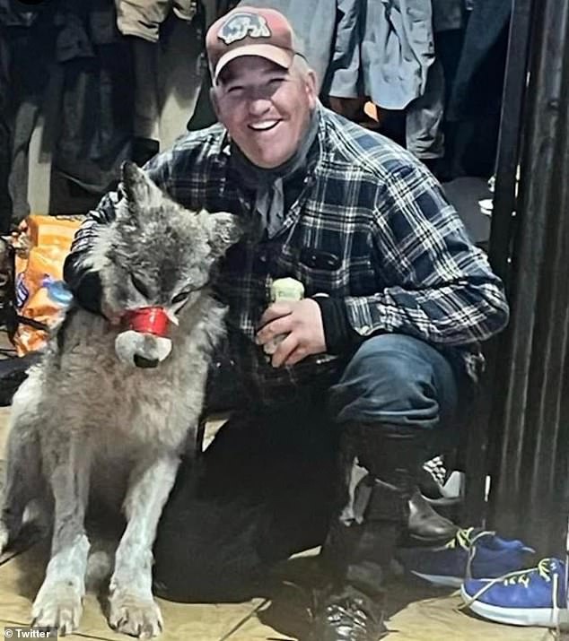 Cody Roberts, 42, posed with the exhausted animal, smiling brightly as he grabbed it by the scruff of the neck and lifted a can of beer