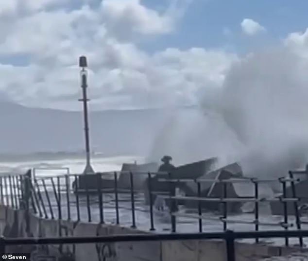 Heartbreaking footage has emerged of a father bravely diving into rough waters to save his daughter who was swept away by a large wave (pictured)